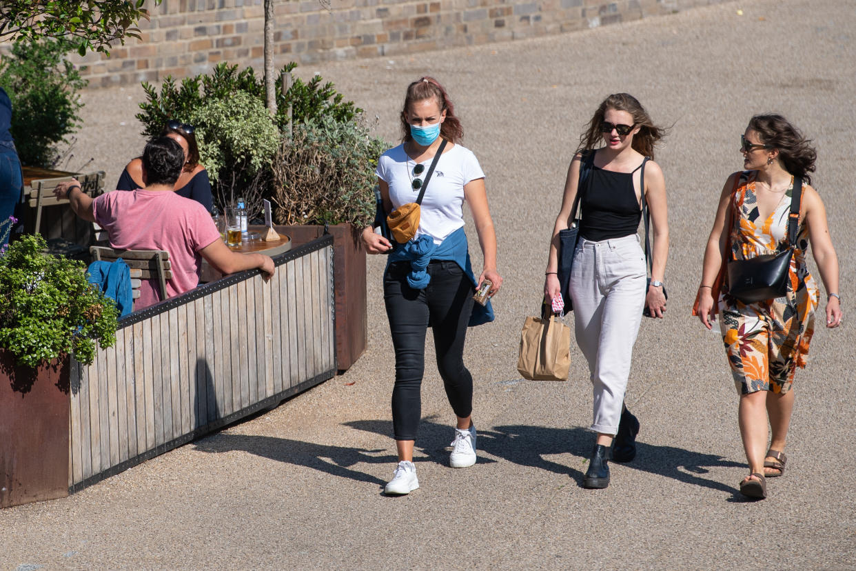 People enjoying the Autumn sunshine in alongside the Regents Canal in London. The public has been urged to act "in tune" with Covid-19 guidelines before the "rule of six" restrictions come into force on Monday.