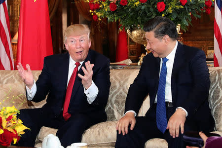 President Donald Trump interacts with Chinese President Xi Jinping at Mar-a-Lago state in Palm Beach, Florida. REUTERS/Carlos Barria