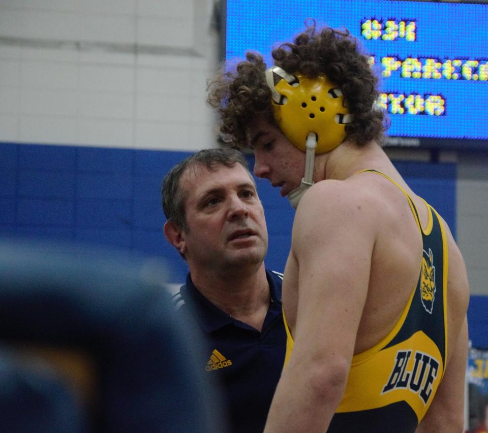 Head coach Jerry LaJoie talks with junior Ty Bensinger during a wrestling match with Petoskey on Wednesday, January 18 at Jim Mongeau Gymnasium in Gaylord, Mich.