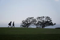 Justin Rose, of England, right, and his caddy walk up the fourth fairway during the first round of the U.S. Open Golf Championship, Thursday, June 17, 2021, at Torrey Pines Golf Course in San Diego. (AP Photo/Gregory Bull)