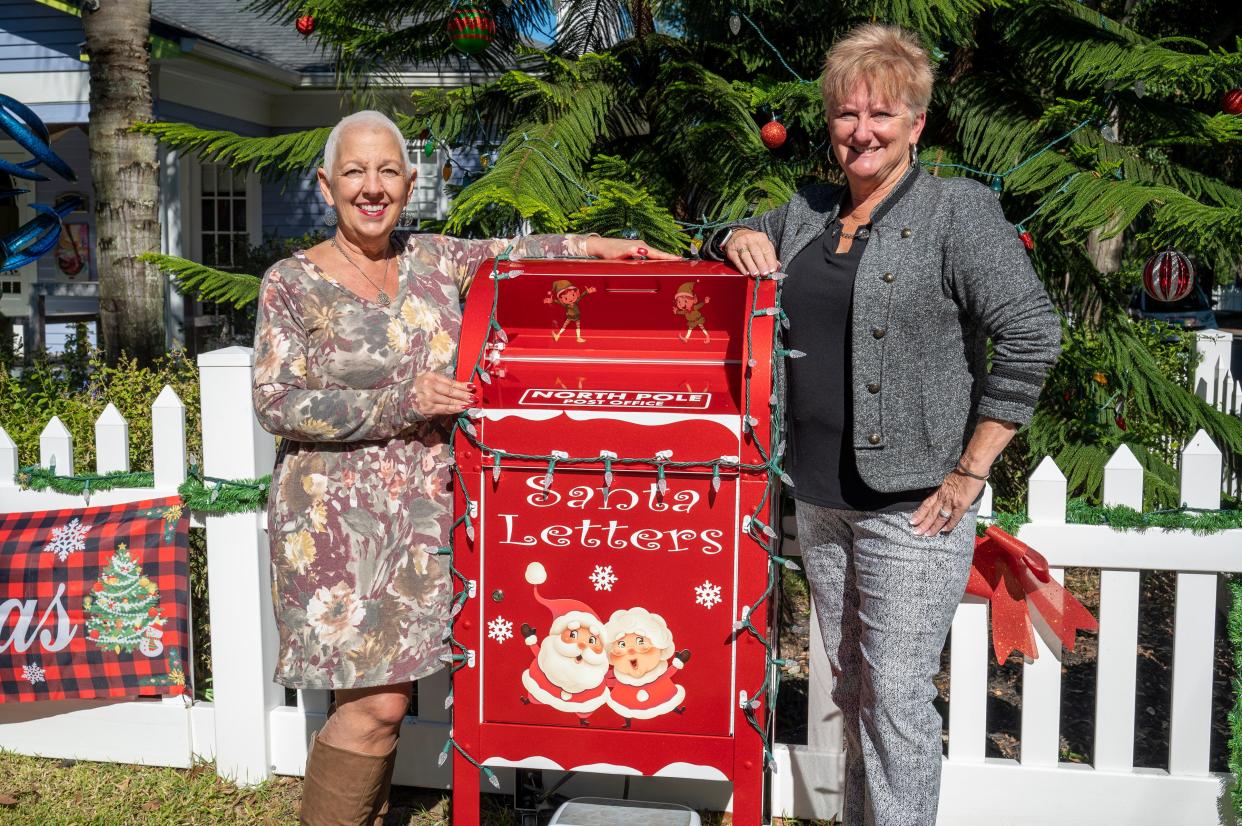 Jeanette and Linda Bokland stand next to their new mail box for their “Letters to Santa” project at their home in Mount Dora.