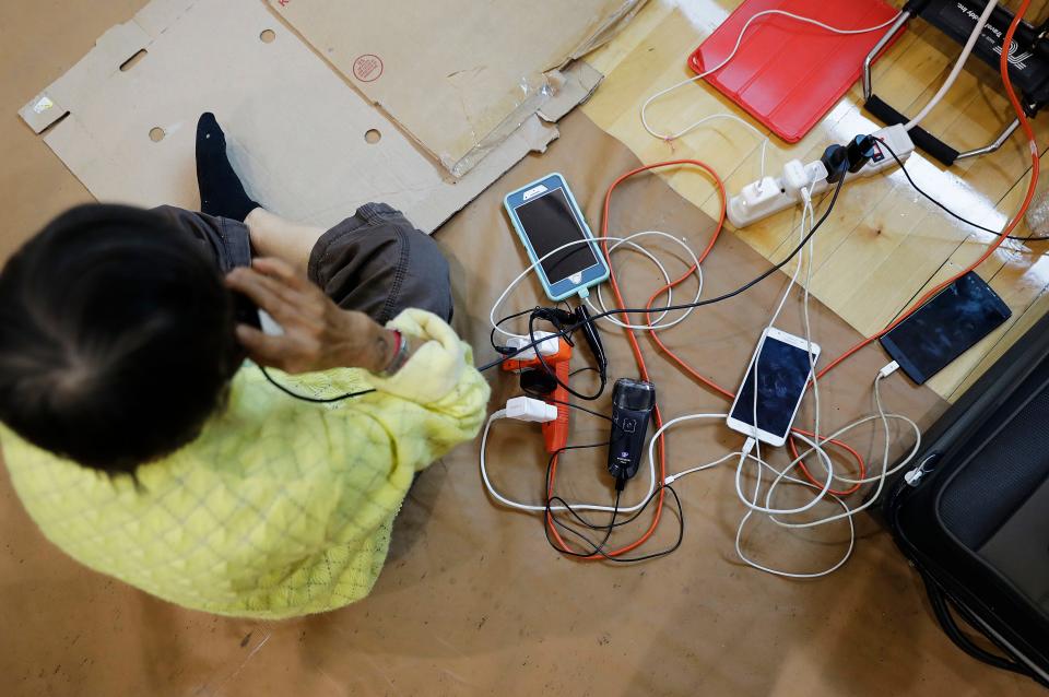 Cell phones and an electric shaver belonging to evacuees are charged at a shelter at Florida International University ahead of Hurricane Irma in Miami, Saturday, Sept. 9, 2017. (AP Photo/David Goldman)