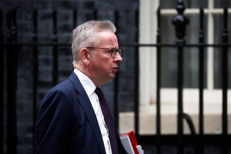 Britain's Housing Secretary Michael Gove walks outside Downing Street in London