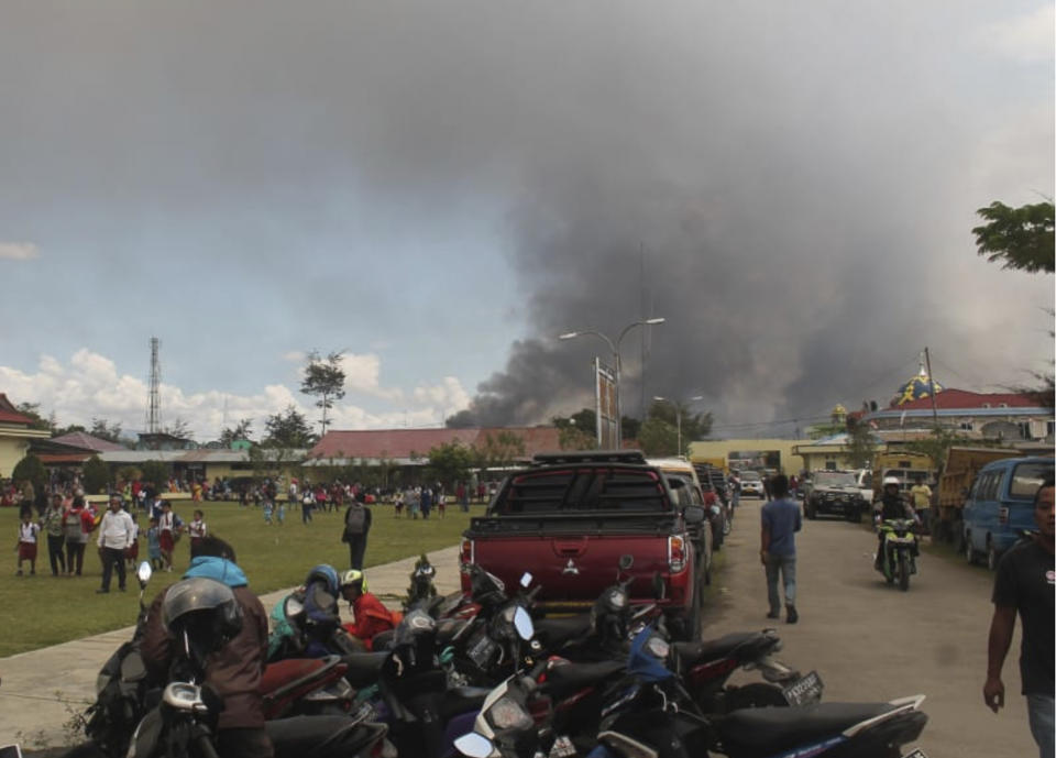 Smoke billows from burning building during protest in Wamena, Papua province, Indonesia, Monday, Sept. 23, 2019. Hundreds of protesters in Indonesia's restive Papua province set fire to homes and other buildings Monday in a protest sparked by rumours that a teacher had insulted students. (AP Photo/George Yewun)