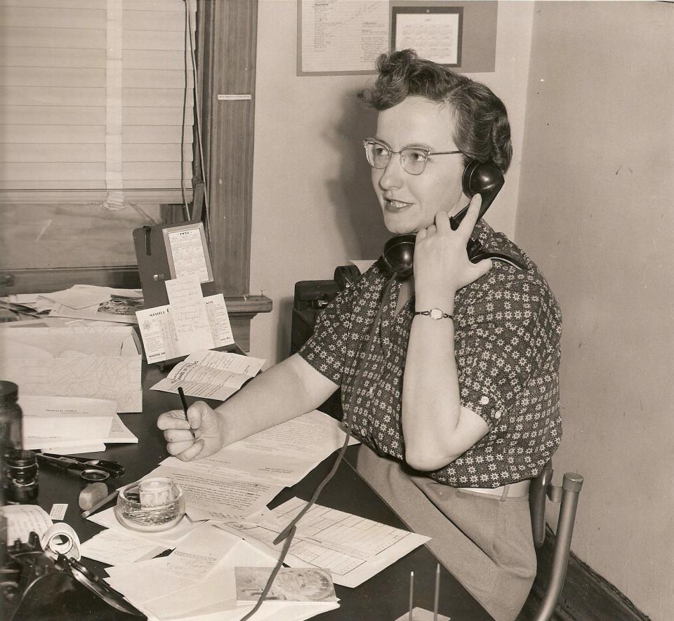 Marge Miley at the Herald Times Reporter's editor’s desk in 1957.