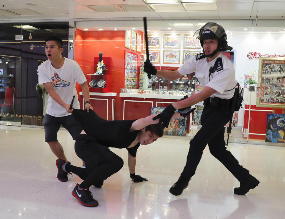 Police detain a young man after fights broke out between pro-China supporters and anti-government protesters at Amoy Plaza in the Kowloon Bay district in Hong Kong, Saturday, Sept. 14, 2019. The clashes came after several nights of peaceful rallies that featured mass singing at shopping malls by supporters of the months-long protests demanding democratic reforms. (AP Photo/Kin Cheung)