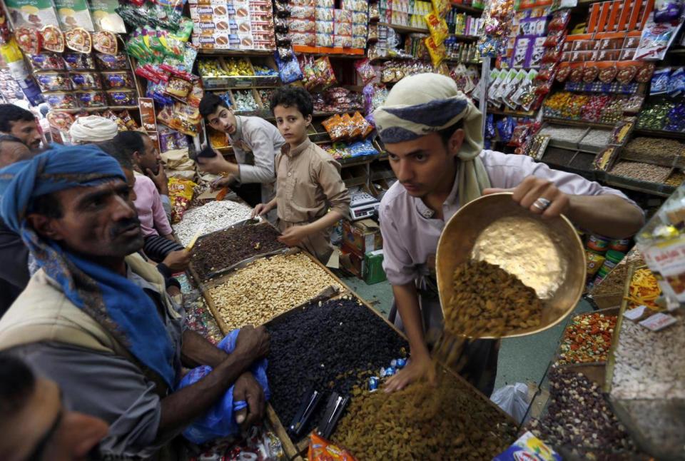 Yemenis buy sweets and nuts at a market in the capital Sanaa (AFP/Getty Images)