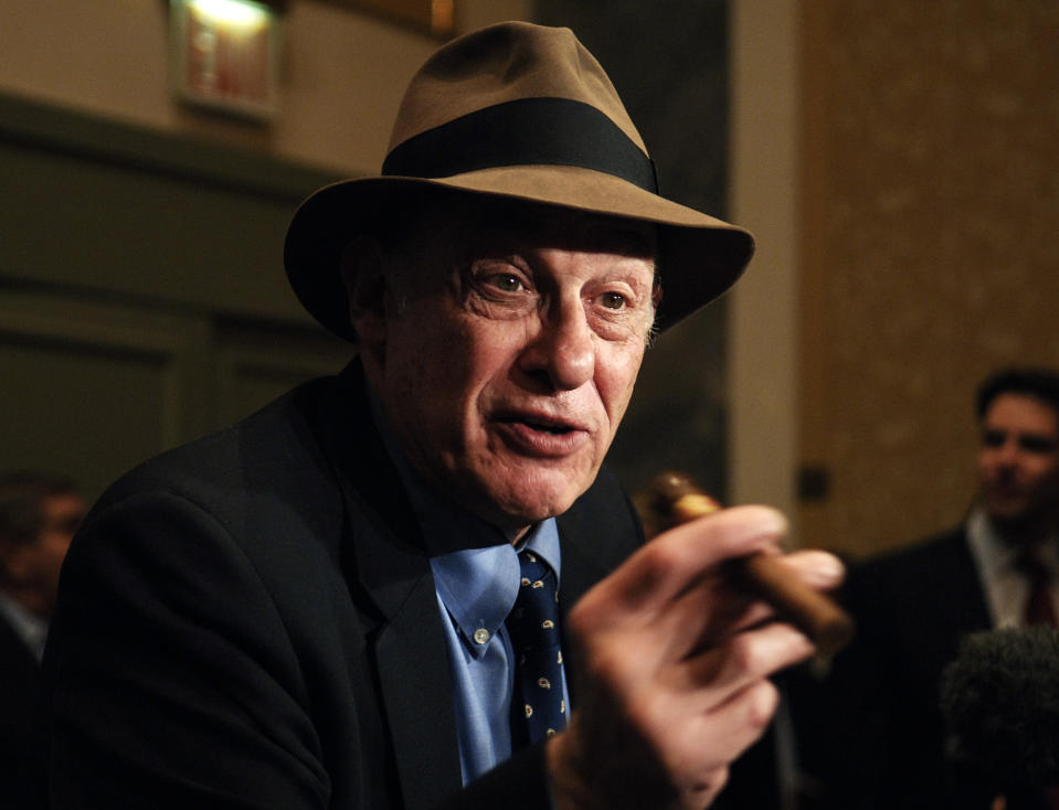 In this file photo taken Oct. 28, 2005, boxing historian Bert Sugar is seen at the Friars Club Roast in New York. Sugar, known for his fedora and cigar, has died. Jennifer Frawley, Sugar's daughter, said cardiac arrest caused his death on Sunday, March 25, 2012. His wife, Suzanne, was by his side when he passed away. (AP Photo/Louis Lanzano, file)