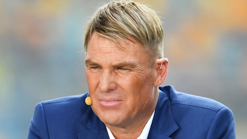 Shane Warne is seen in this picture in his media role covering cricket.