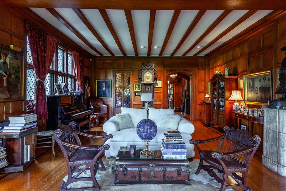 a living room with a piano and a couch