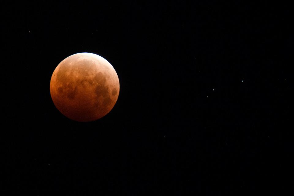 The full moon is seen during totality of a total lunar eclipse as the moon enters Earth's shadow for a  super blood moon on May 26, 2021, in Chico, California.