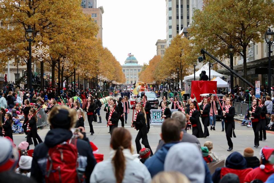 People line up along Fayetteville Street to watch performers pass by during the Raleigh Christmas Parade in Raleigh, N.C. on November 23, 2019.