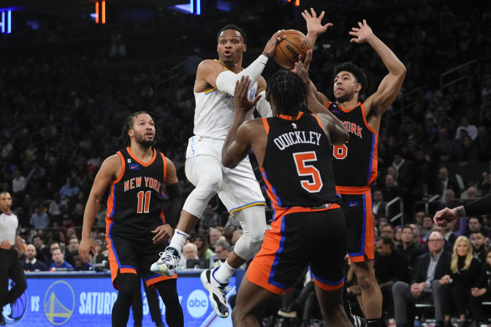 Los Angeles Lakers' Russell Westbrook, center, passes away from New York Knicks' Jalen Brunson (11), Immanuel Quickley (5) and Quentin Grimes (6) during the second half of an NBA basketball game Tuesday, Jan. 31, 2023, in New York. (AP Photo/Frank Franklin II)