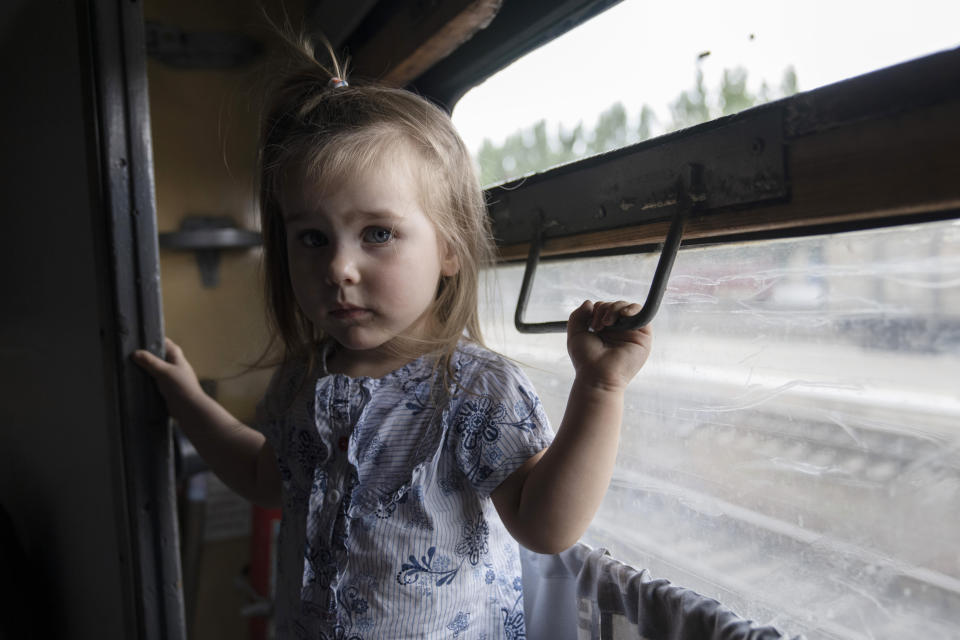 Internally displaced Kira from Toretsk stands inside a train heading to Dnipro, at the Pokrovsk train station, Donetsk region, eastern Ukraine, Friday, July 8, 2022. (AP Photo/Nariman El-Mofty)
