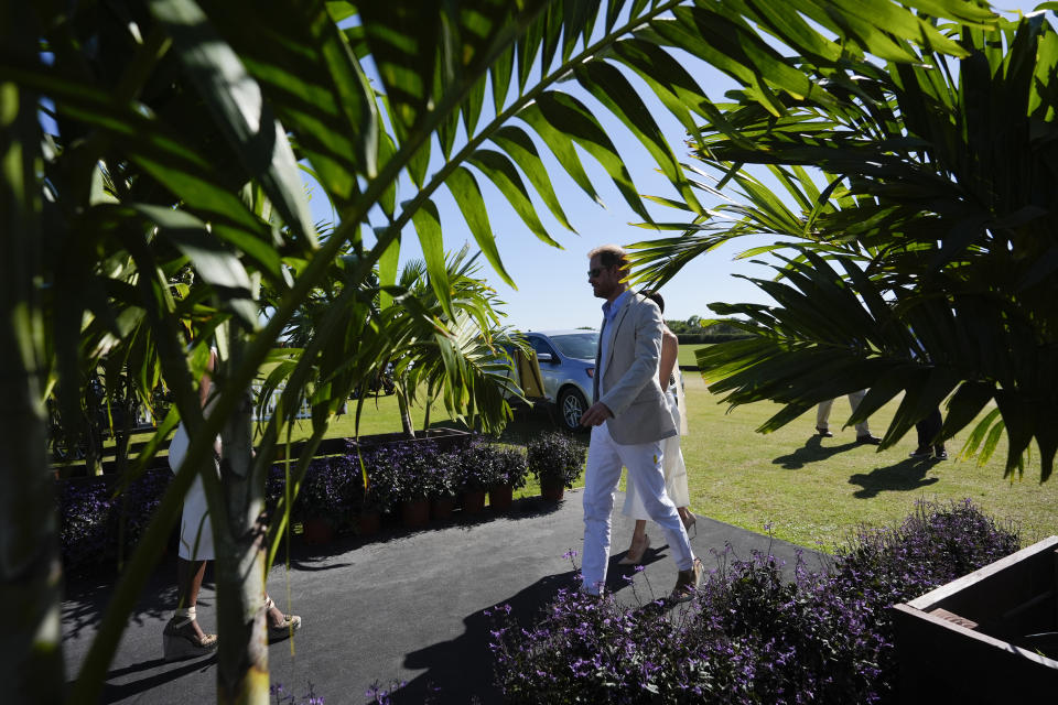 Britain's Prince Harry and wife Meghan Markle, Duchess of Sussex, obscured, arrive for the 2024 Royal Salute Polo Challenge to Benefit Sentebale, Friday, April 12, 2024, in Wellington, Fla. Prince Harry, co-founding patron of the Sentebale charity, will play on the Royal Salute Sentebale Team. (AP Photo/Rebecca Blackwell)