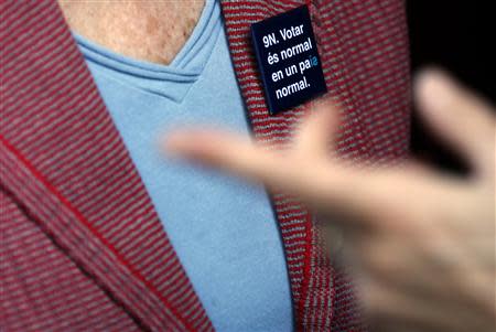 Muriel Casals, chairman of Omnium Cultural, an independent association created to promote the Catalan language and spread Catalan culture, wears a pin reading "9N (in reference to November 9, 2014, the planned day for the Catalan referendum). REUTERS/Sergio Perez