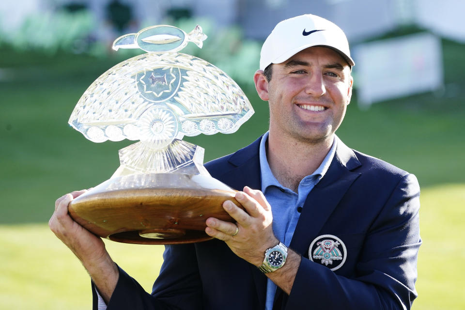 Scottie Scheffler holds up the championship trophy after the final round of the Phoenix Open golf tournament, Sunday, Feb. 12, 2023, in Scottsdale, Ariz. (AP Photo/Darryl Webb)