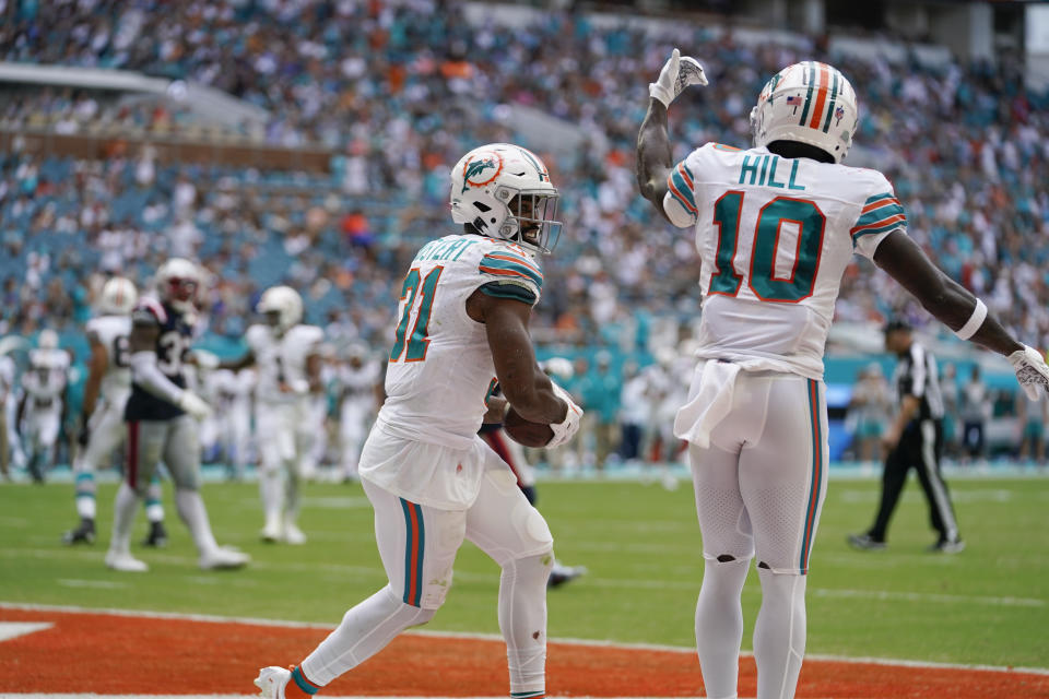 Miami Dolphins running back Raheem Mostert (31) catches the ball for a touchdown during the second half of an NFL football game against the New England Patriots, Sunday, Oct. 29, 2023, in Miami Gardens, Fla. (AP Photo/Lynne Sladky)