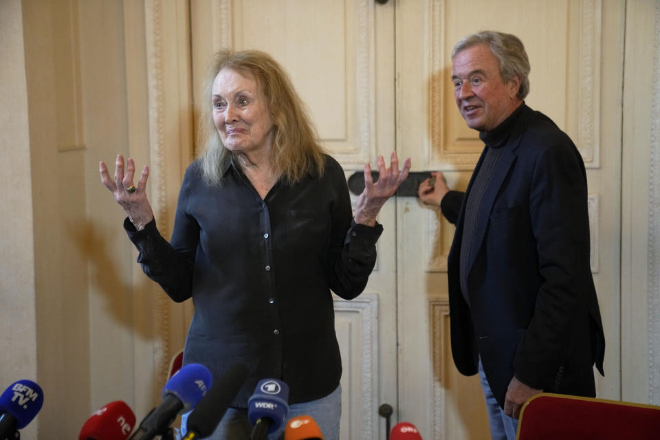 French author Annie Ernaux, left, and Chairman of French publishing house Gallimard, Antoine Gallimard, right, at the end of a press conference after Ernaux was awarded 2022's Nobel Prize in literature, in Paris, Thursday, Oct. 6, 2022. The 82-year-old was cited for "the courage and clinical acuity with which she uncovers the roots, estrangements and collective restraints of personal memory," the Nobel committee said. (AP Photo/Michel Euler)