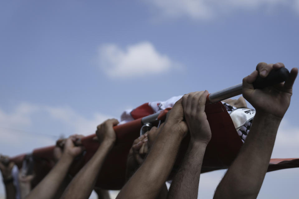 Palestinian mourners carry the body of Ezzedin Kanan, 20, who succumbed to his wounds sustained during an Israeli army operation last month, during his funeral in the West Bank city of Jenin, Saturday, Aug. 26, 2023. The July 3 raid was the most intense Israeli military operation in years in the West Bank, involving airstrikes and hundreds of ground troops, that left a wide swath of damage in its wake. Kanan's death brings the death toll in the raid to 13. (AP Photo/Nasser Nasser)