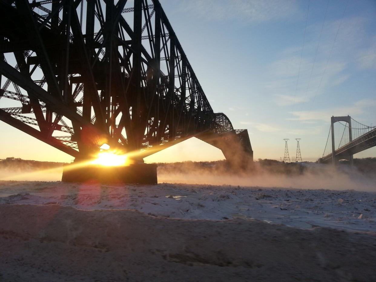 A view of the Pont de Québec as the sun rises. The federal government has reached an agreement to buy back the bridge which was privatized in 1993.  (Geneviève Poulin/Radio-Canada - image credit)