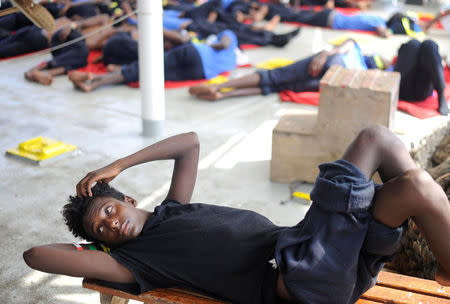 A migrant is seen resting on board of the MV Aquarius rescue ship run by SOS Mediterranee organisation and Doctors Without Borders during a search and rescue (SAR) operation in the Mediterranean Sea, off the Libyan Coast, August 12, 2018. Picture taken August 12, 2018. REUTERS/Guglielmo Mangiapane