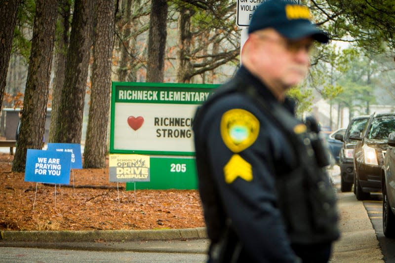 A Newport News police officer directs traffic at Richneck Elementary School in Newport News, Va., on Monday Jan. 30, 2023. The Virginia elementary school where a 6-year-old boy shot his teacher has reopened with stepped-up security and a new administrator. 

