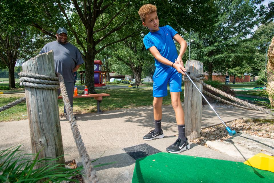 Jeremik Blanks, from Chapman, plays goofy golf with his father, Albert Blanks at the Sports Center, which offers putt-putt courses as well as karting, a batting cage, driving range an indoor arcade games.