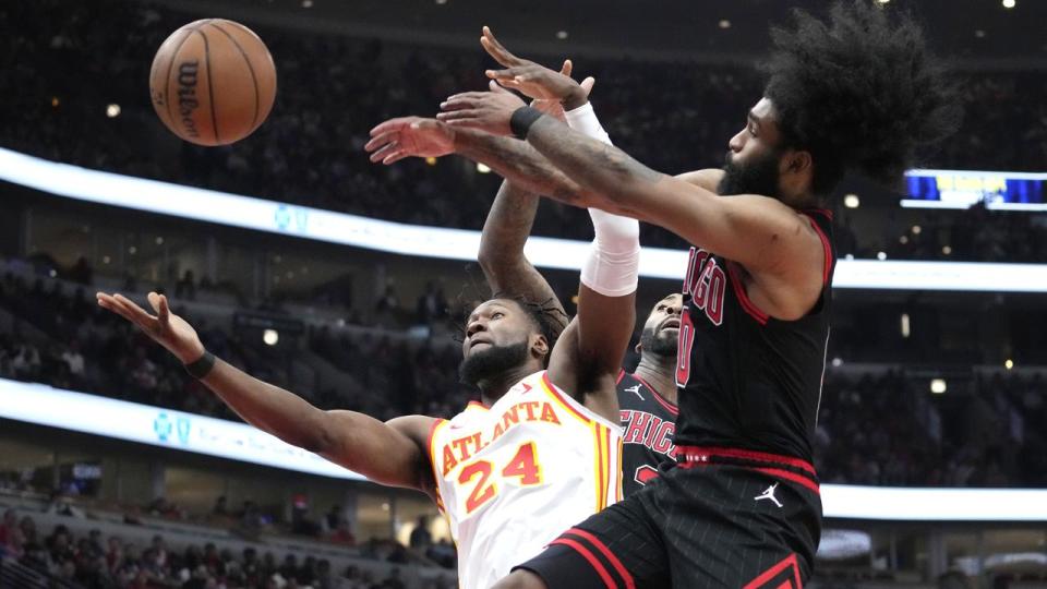 Bruno Fernando (No.24) and Bulls guard Coby White (right)