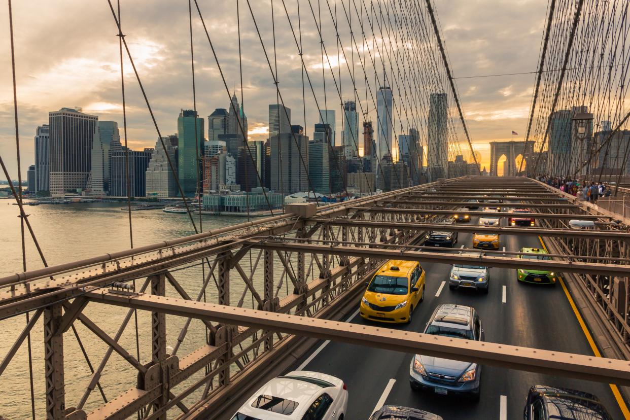 Manhattan with Brooklyn Bridge in the foreground at sunset