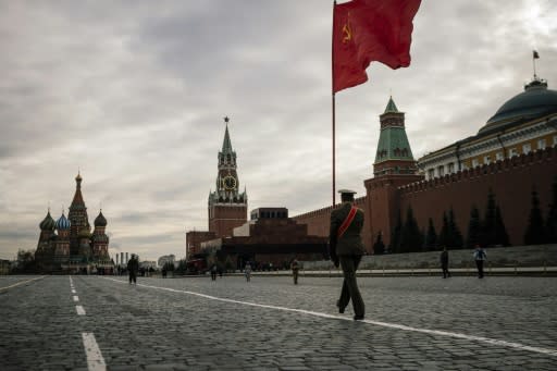 Russian Communist party activists and supporters march towards Lenin's Mausoleum for a ceremony on Red Square in Moscow