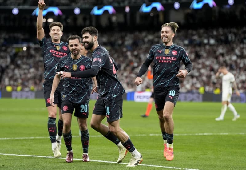 Manchester City's Josko Gvardiol (2nd R) celebrates scoring his side's third goal with Bernardo Silva (2nd L) during the UEFA Champions League quarter-final first leg soccer match between Real Madrid and Manchester City at the Santiago Bernabeu Stadium. Nick Potts/PA Wire/dpa