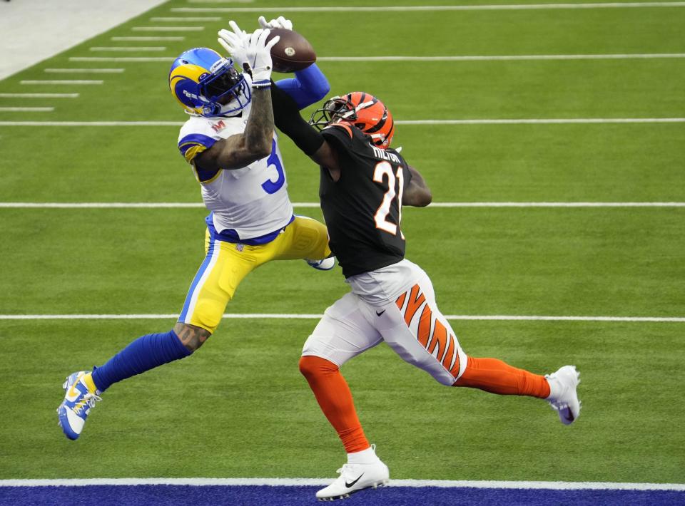 Rams wide receiver Odell Beckham Jr. leaps over Bengals cornerback Mike Hilton to score the first touchdown in Super Bowl 56.