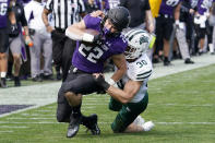 Northwestern running back Connor Newhouse, left, is tackled by Ohio linebacker Ben Johnson during the second half of an NCAA college football game in Evanston, Ill., Saturday, Sept. 25, 2021. Northwestern won 35-6. (AP Photo/Nam Y. Huh)