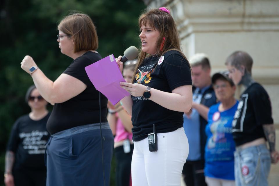 Kurstin Gaudent kicks off an abortion-rights event Saturday on the Statehouse south steps to a crowd of a few hundred gathered below.