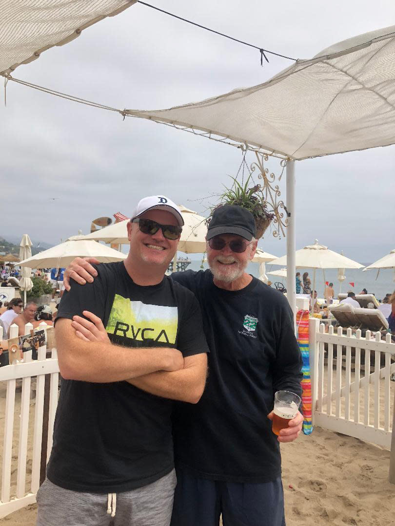 This undated photo provided by Kathleen McIlvain shows Charles McIlvain, left, and his father Clark posing for a photo. Charles died aboard the dive boat Conception during a Sept. 2 fire that killed 34 people. (Kathleen McIlvain via AP)