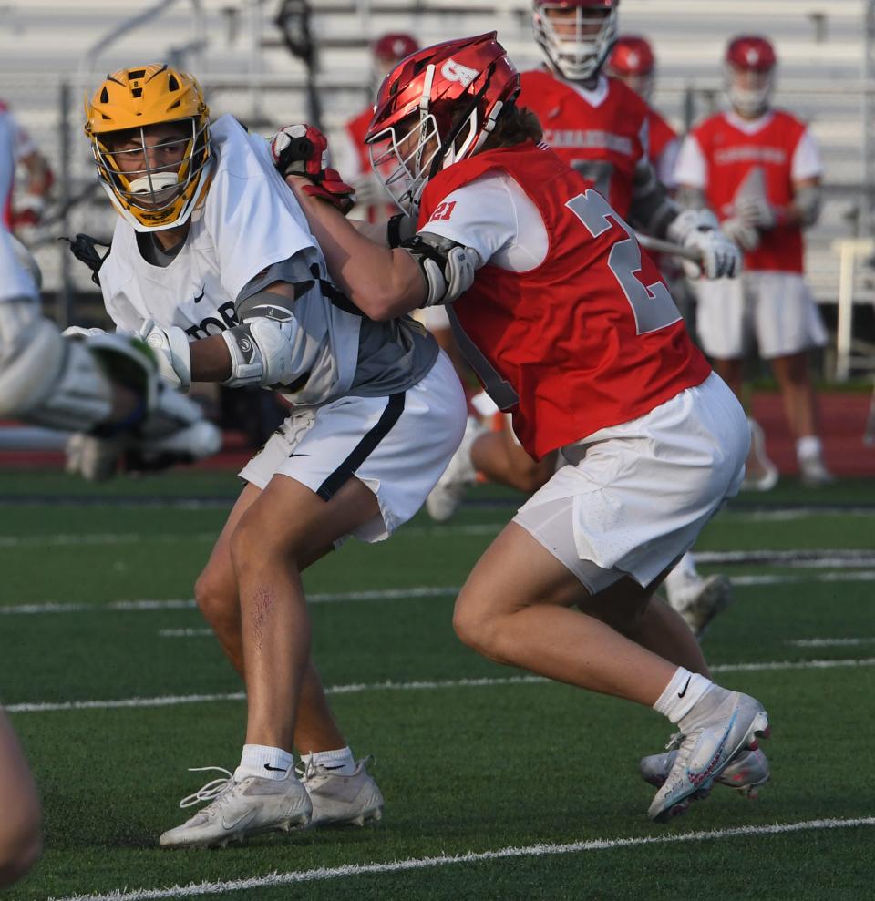 Victor's Jack Herendeen works againstt Canandaigua's Dominic Gullace.