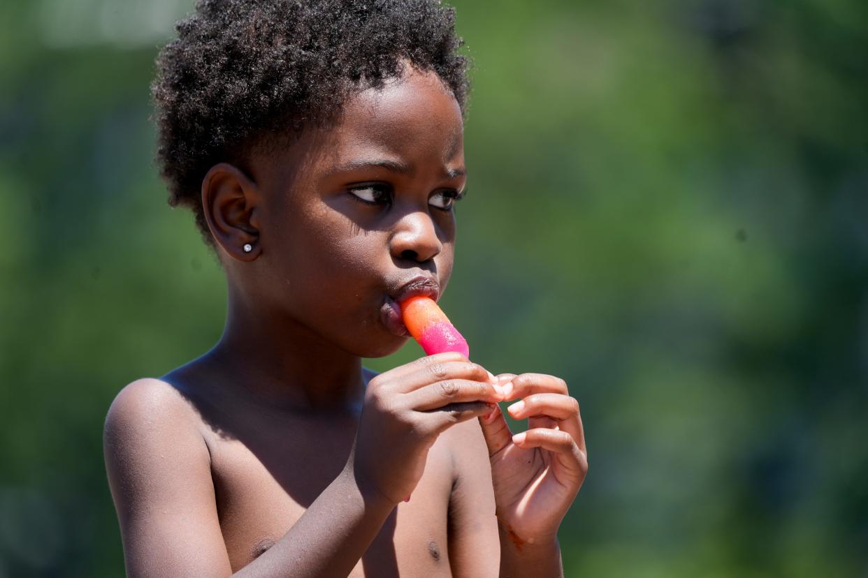 Lennox Clark, 4, eats a popsicle Sunday at Washington Park in Cincinnati. The first heat wave of the year has hit with high temperatures continuing all week.