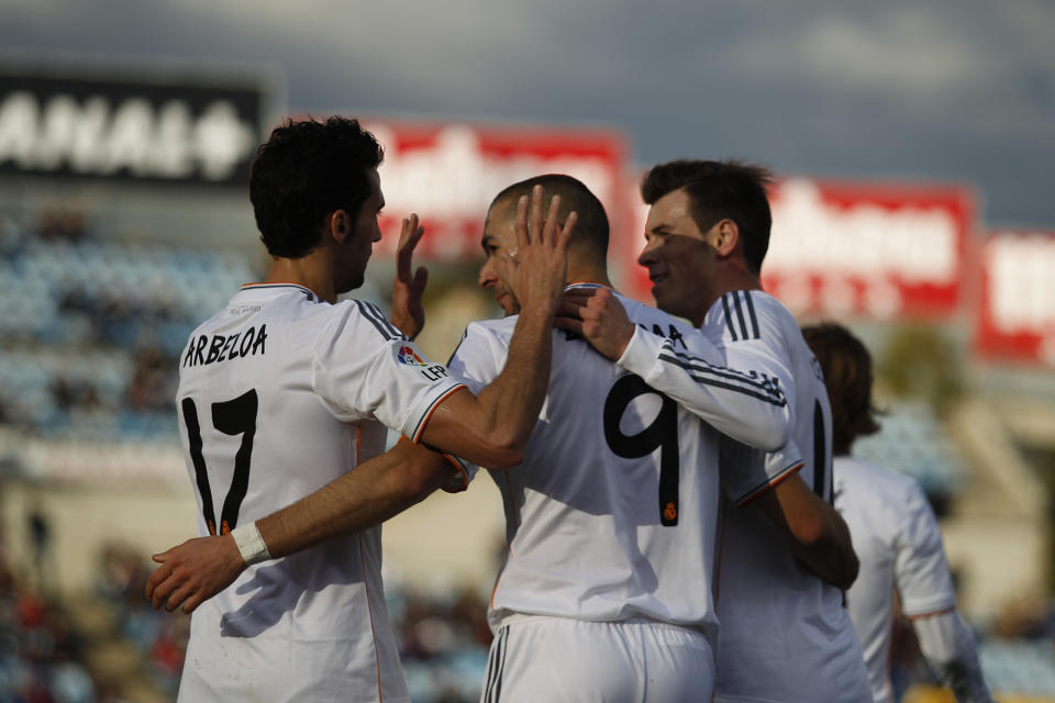 Real's Karim Benzema, center, celebrates his goal with teammates during a Spanish La Liga soccer match between Real Madrid and Getafe at the Coliseum Alfonso Perez stadium in Madrid, Spain, Sunday, Feb. 16, 2014. (AP Photo/Gabriel Pecot)