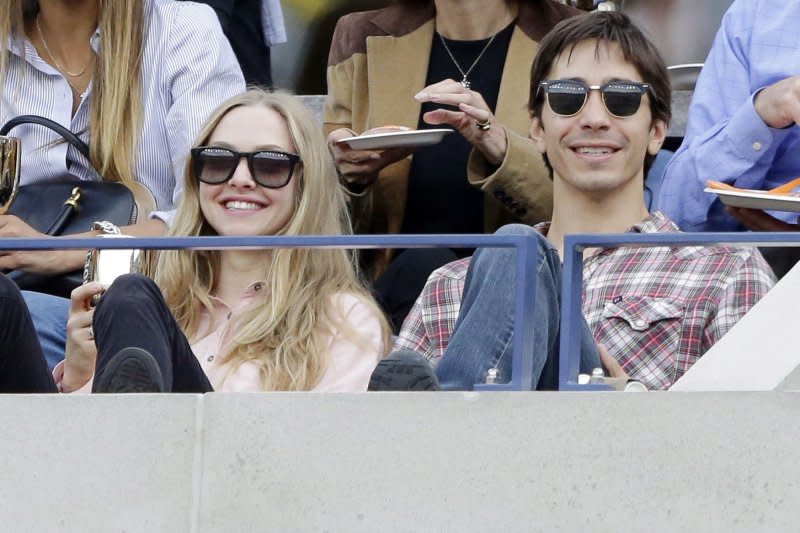 Amanda Seyfried and Justin Long watch Novak Djokovic of Serbia play Rafael Nadal of Spain in the Mens Final in Arthur Ashe Stadium at the U.S. Open Tennis Championships at the USTA Billie Jean King National Tennis Center in New York City in 2013. File Photo by John Angelillo/UPI