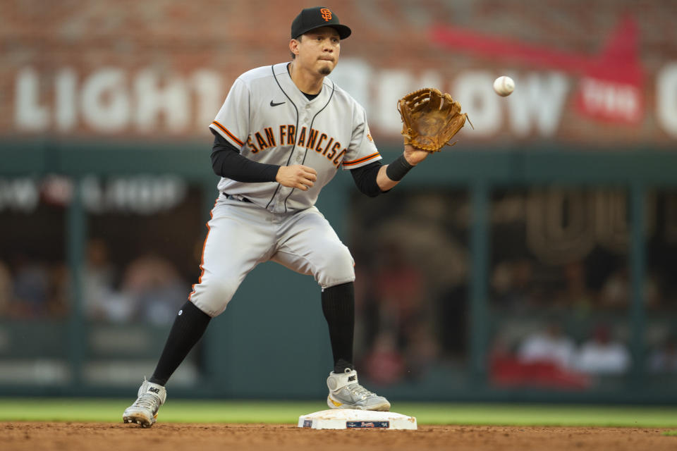 San Francisco Giants second baseman Wilmer Flores makes catch and tag in the third inning of a baseball game against the Atlanta Braves, Monday, June 20, 2022, in Atlanta. (AP Photo/Hakim Wright Sr.)