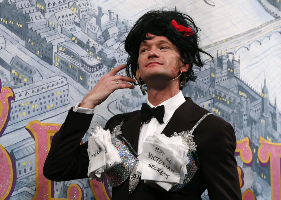 Actor Neil Patrick Harris is dressed in a bra and wig during his roast as Man of The Year by Harvard University's Hasty Pudding Theatricals in Cambridge, Mass., Friday, Feb. 7, 2014. (AP Photo/Elise Amendola)