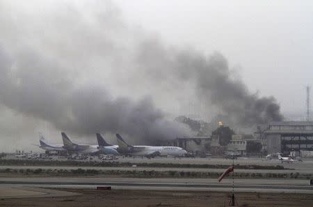 Smoke billows from Jinnah International Airport in Karachi in this June 9, 2014 file photo. Taliban militants attacked Jinnah International Airport in Karachi on Sunday night, sparking a five-hour gun battle that killed at least 34 people. All 10 militants were dead by dawn, shot down by the security forces or blown up by their own suicide vests. REUTERS/Athar Hussain/Files