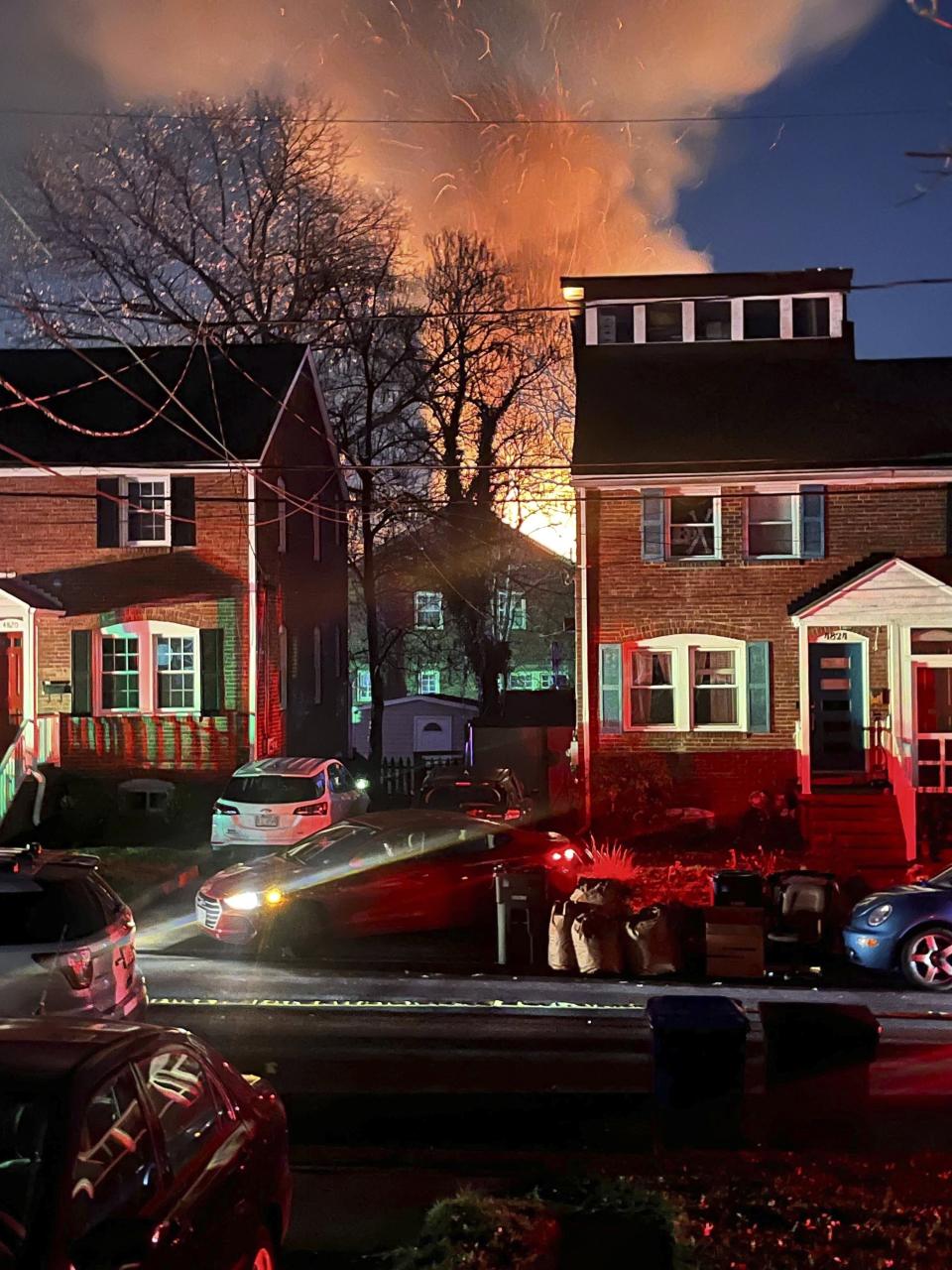 FILE - A home is seen exploding from a distance, Monday night, Dec. 4, 2023, in Arlington, Va. A man who died in a house explosion six months ago outside the nation’s capital deliberately detonated gasoline canisters in his basement that caused the blast, authorities said Friday, June 7, 2024. (AP Photo, file)