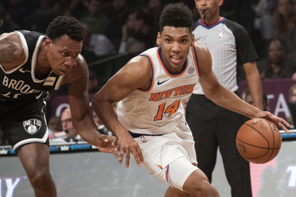 New York Knicks guard Allonzo Trier (14) drives to the basket against Brooklyn Nets guard Treveon Graham (21) during the first half of an NBA basketball game, Friday, Oct. 19, 2018, in New York. (AP Photo/Mary Altaffer)