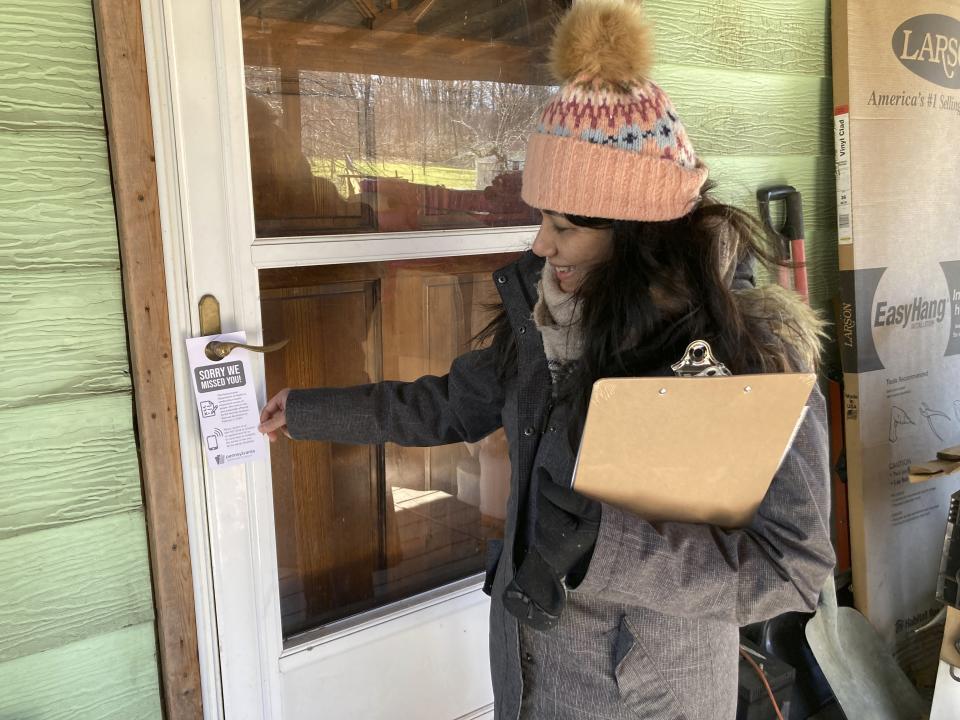 Vidisha Parasram of the National Institute for Occupational Safety and Health visits a house, Feb. 26, 2023, in Darlington Township, Pa. The community is across the state line from East Palestine, Ohio, where a Feb. 3 train derailment has raised fears of air and water contamination. Federal and state officials have been going door to door inviting residents to take a health assessment. (AP Photo/John Flesher)