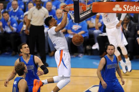 Apr 25, 2016; Oklahoma City, OK, USA; Oklahoma City Thunder guard Russell Westbrook (0) dunks the ball in front of Dallas Mavericks forward Dirk Nowitzki (41) during the first quarter in game five of the first round of the NBA Playoffs at Chesapeake Energy Arena. Mark D. Smith-USA TODAY Sports