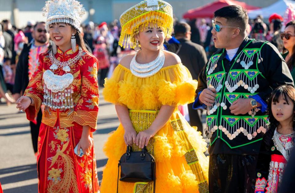 Allison Vang, left and her cousin See Vang, center, of Fresno, participate in the ball toss as Danny Xiong of Stockton comes up to talk to them during the Sacramento Hmong New Year festival Saturday.