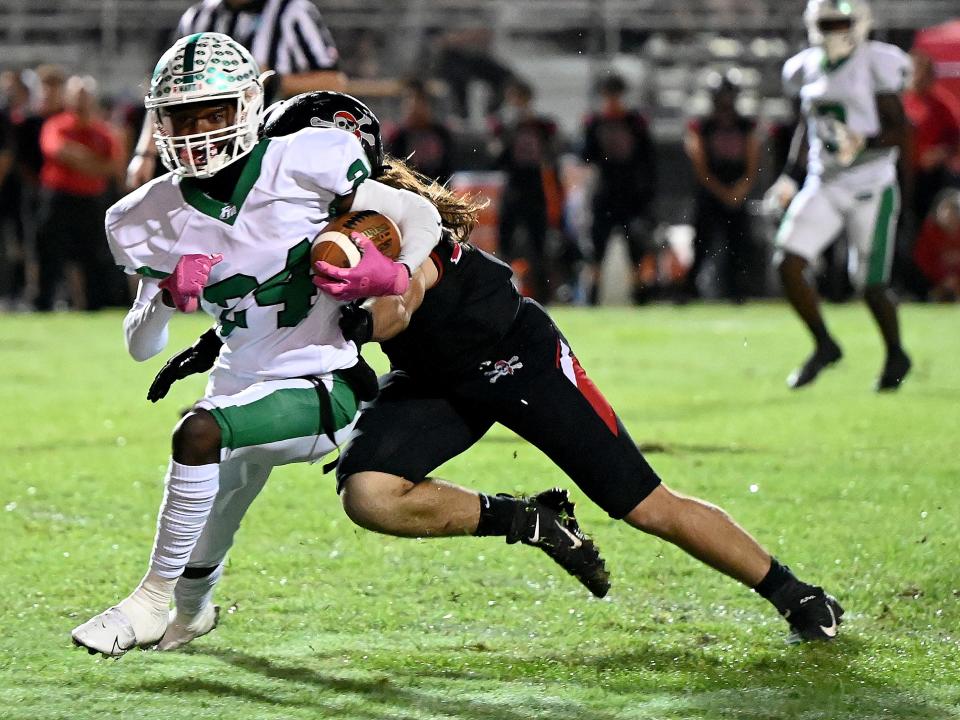 Fort Myers High School’s Madrid Tucker (24) runs the ball during their game against Port Charlotte High School. Friday, Nov. 11, 2022.(Photo/Chris Tilley)