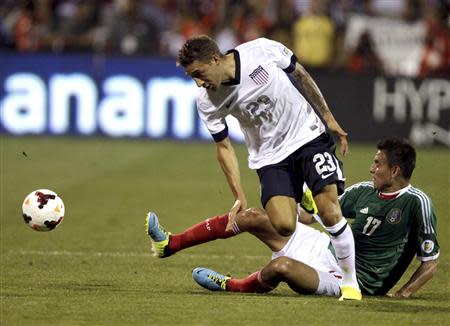 United States' Fabian Johnson (23) fights for the ball with Mexico's Jesus Zavala during the first half of their 2014 World Cup qualifying soccer match in Columbus, Ohio September 10, 2013. REUTERS/Matt Sullivan
